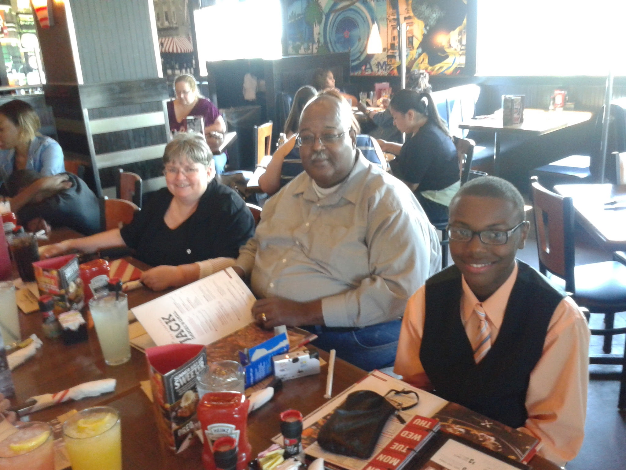 Gerald, Dodi, and Dontae at a restaurant