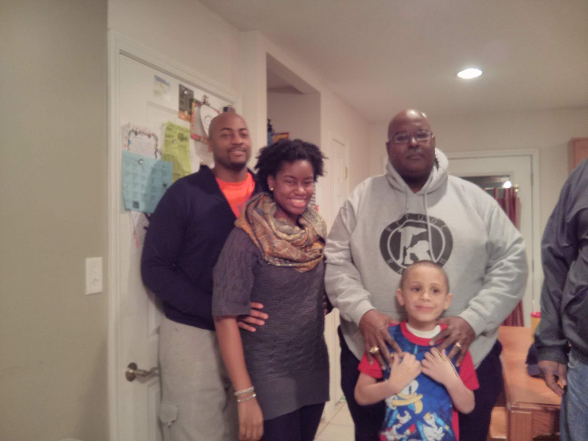 Gerald with his children and grandchild