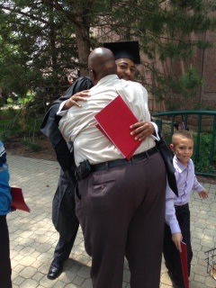 Gerald W. Raines Sr. sharing a proud embrace with his son at graduation