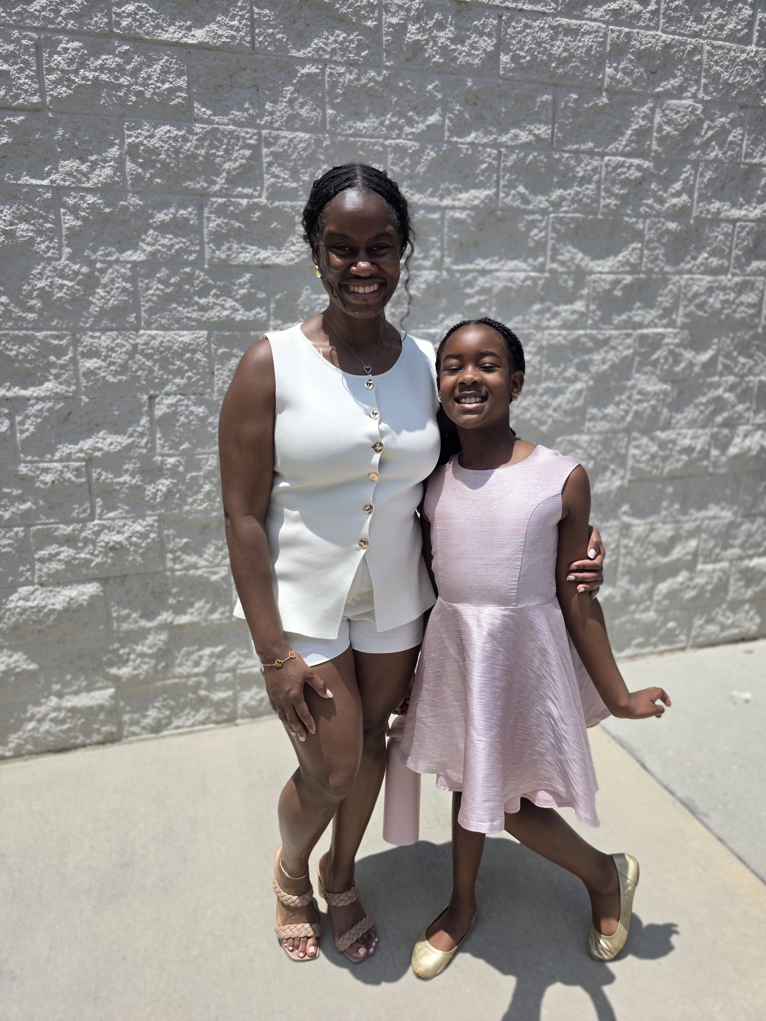 Alyscia with her daughter in the soft pink dress